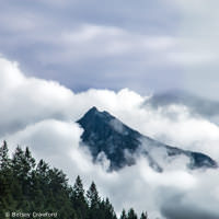 Mountain top in the clouds in Golden, British Columbia by Betsey Crawford