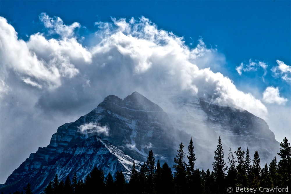 A mountain and its clouds on the road between Banff and Lake Louise, Alberta, Canada by Betsey Crawford