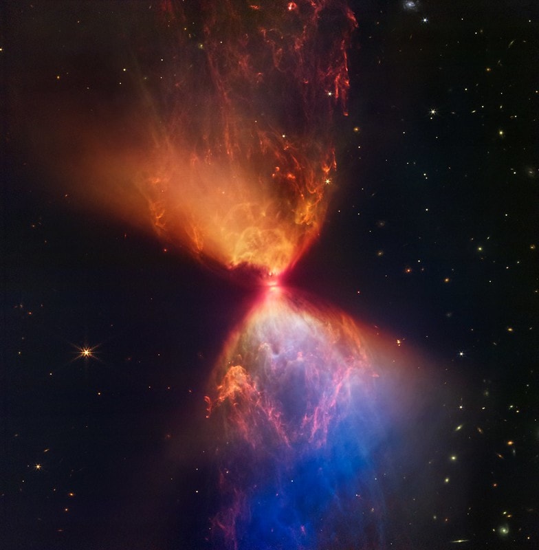 Hourglass in orange and blue formed by star formation via Webb telescope. Photo from NASA