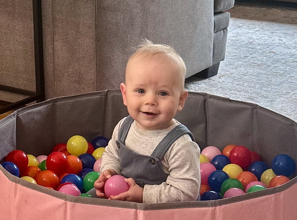 Grandson Jackson looking very sweet in a small pool of different colored balls.